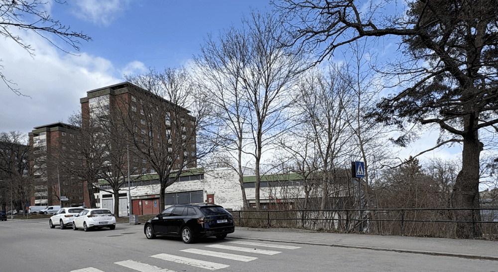 Idag. Vy från Larsbergsvägen med parkeringshuset, fotbollsplan och bebyggelsen i Larsberg.